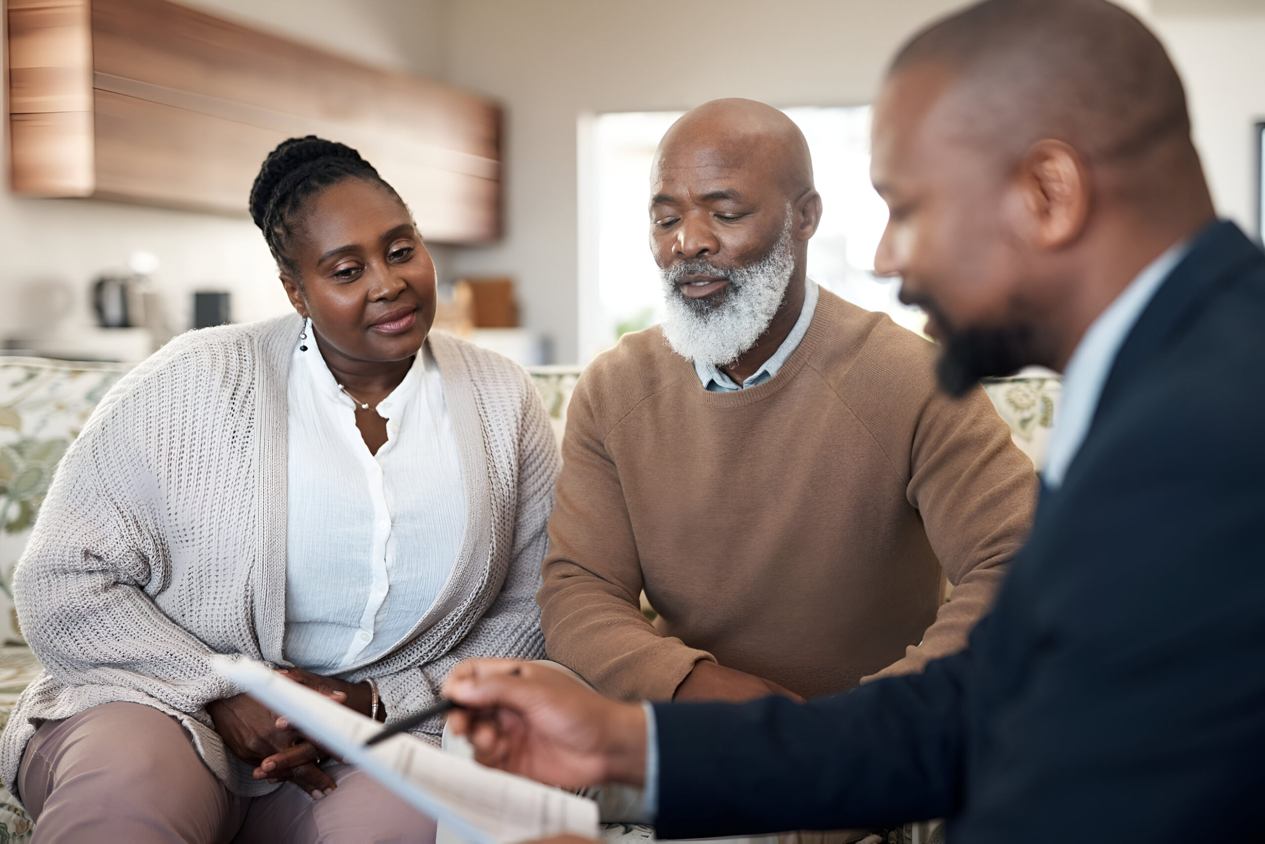 mature-black-couple-discussing-their-finances-planning-retirement-with-advisor-home